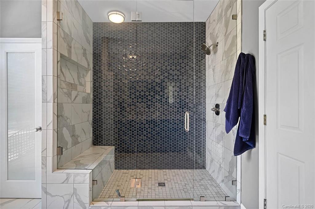 7915 Park Road Charlotte, NC 28210 - Photo 17 of 40 a bathroom with a bathtub and shower