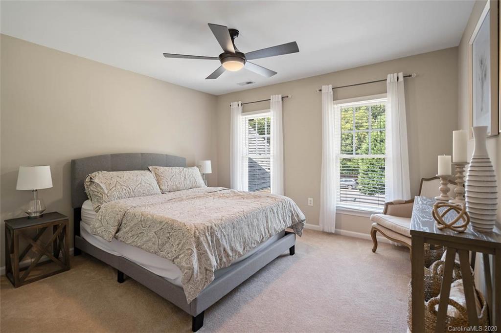 7915 Park Road Charlotte, NC 28210 - Photo 19 of 40 a spacious bedroom with a bed a couch and a large window