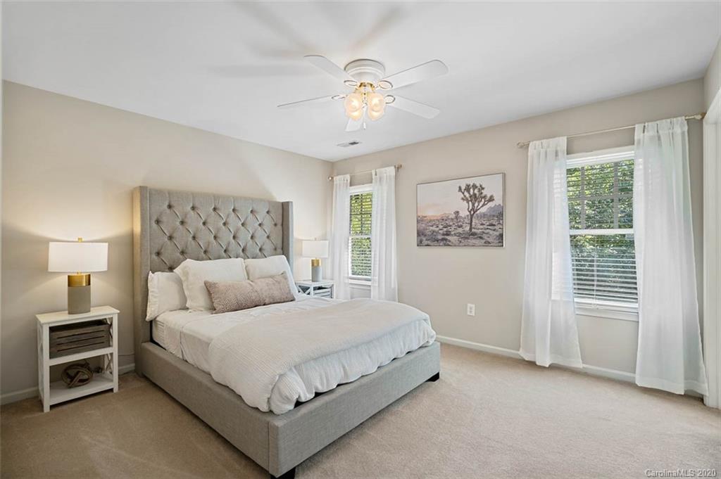 7915 Park Road Charlotte, NC 28210 - Photo 20 of 40 a bedroom with a bed and a chandelier