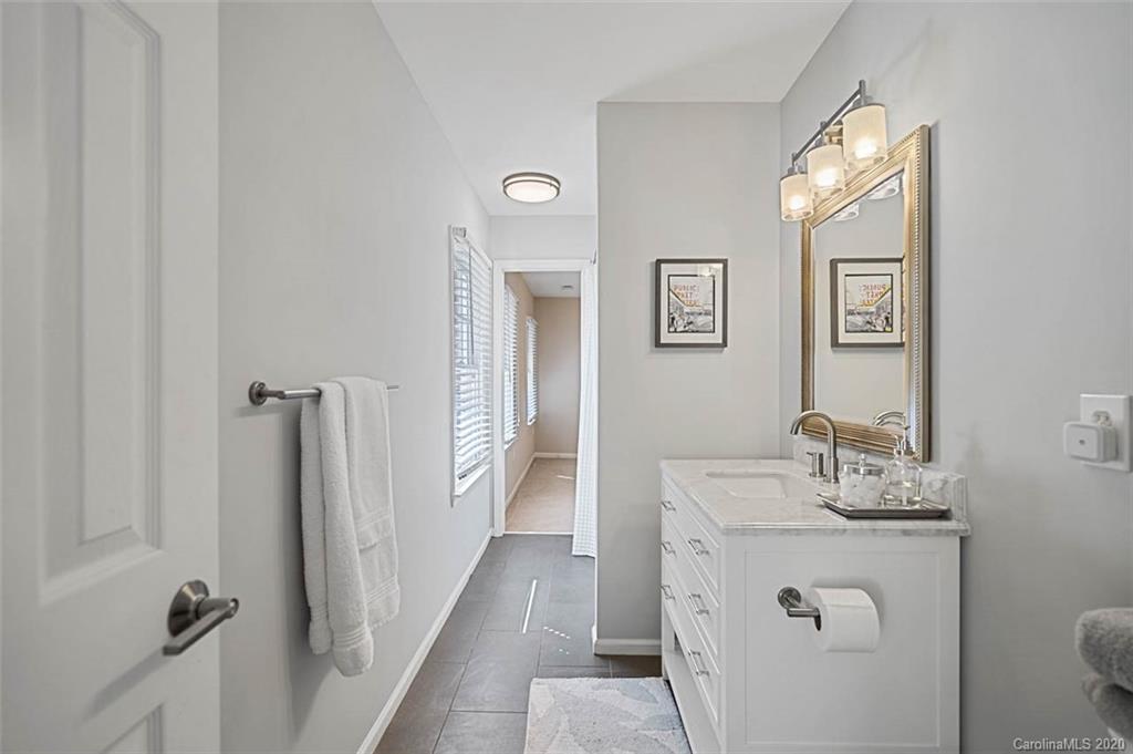 7915 Park Road Charlotte, NC 28210 - Photo 26 of 40 a bathroom with a sink a toilet and shower