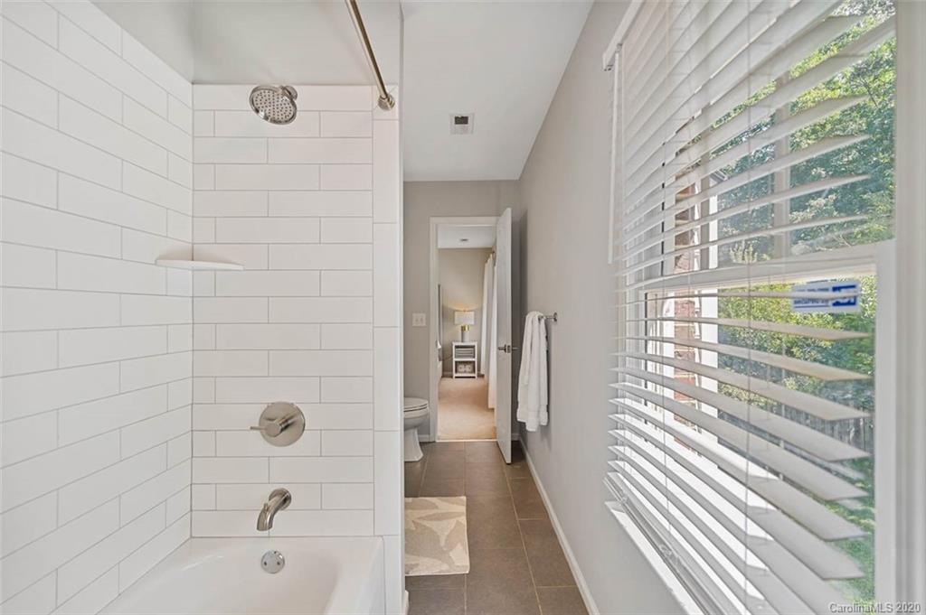 7915 Park Road Charlotte, NC 28210 - Photo 27 of 40 a bathroom with a bathtub and shower