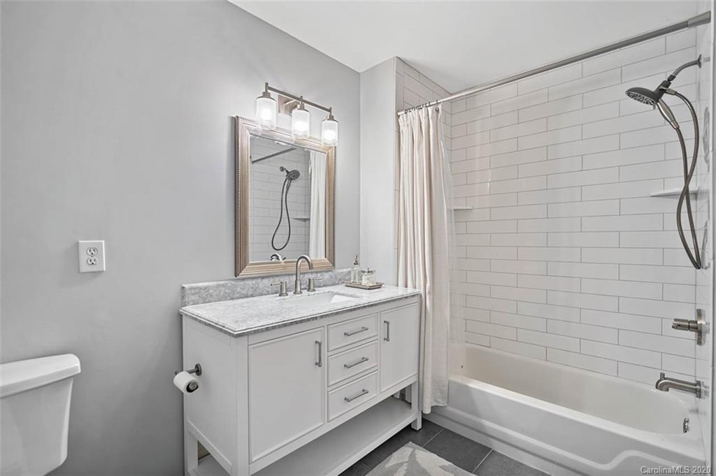 7915 Park Road Charlotte, NC 28210 - Photo 28 of 40 a bathroom with a granite countertop sink a toilet and shower