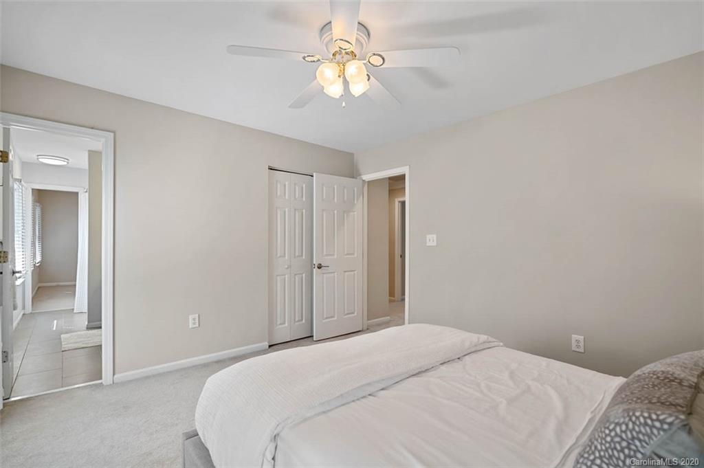 7915 Park Road Charlotte, NC 28210 - Photo 31 of 40 a bedroom with a bed and a chandelier fan