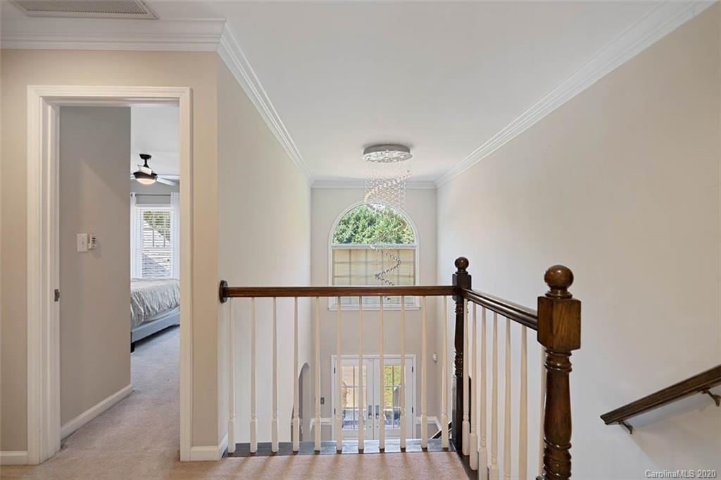 7915 Park Road Charlotte, NC 28210 - Photo 34 of 40 a view of a hallway with wooden floor and stairs