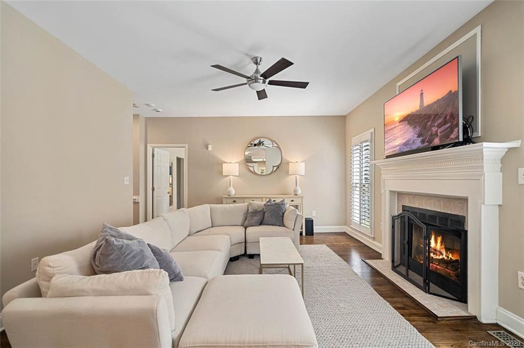 7915 Park Road Charlotte, NC 28210 - Photo 10 of 40 a living room with furniture a clock and a fireplace