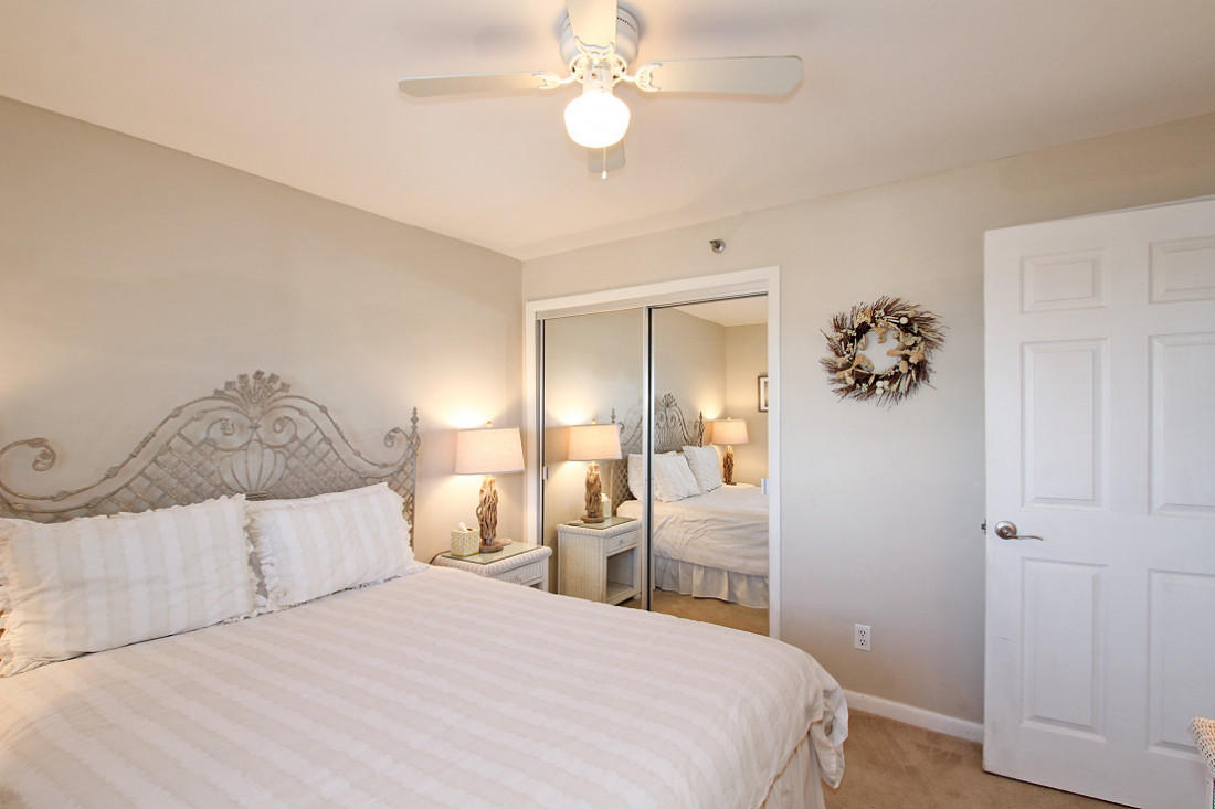 4100 East Scenic Highway, Unit 1307 Santa Rosa Beach, FL 32459 - Photo 16 of 28 a bedroom with a bed and a chandelier