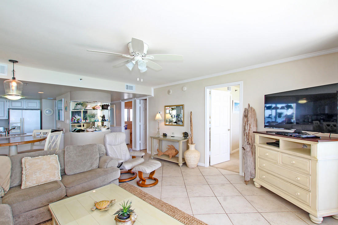 4100 East Scenic Highway, Unit 1307 Santa Rosa Beach, FL 32459 - Photo 4 of 28 a living room with furniture a flat screen tv and kitchen view