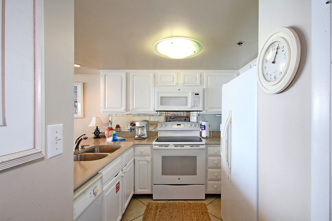 4100 East Scenic Highway, Unit 1307 Santa Rosa Beach, FL 32459 - Photo 8 of 28 a kitchen with a stove top oven sink and cabinets