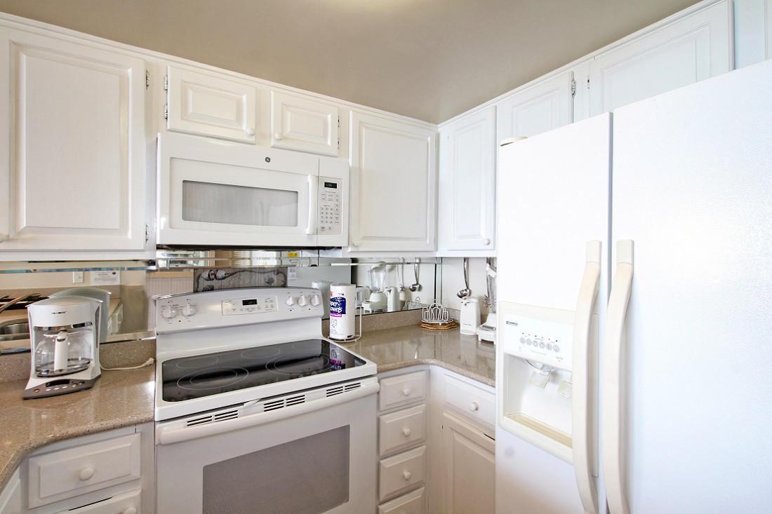 4100 East Scenic Highway, Unit 1307 Santa Rosa Beach, FL 32459 - Photo 9 of 28 a kitchen with white cabinets and white appliances