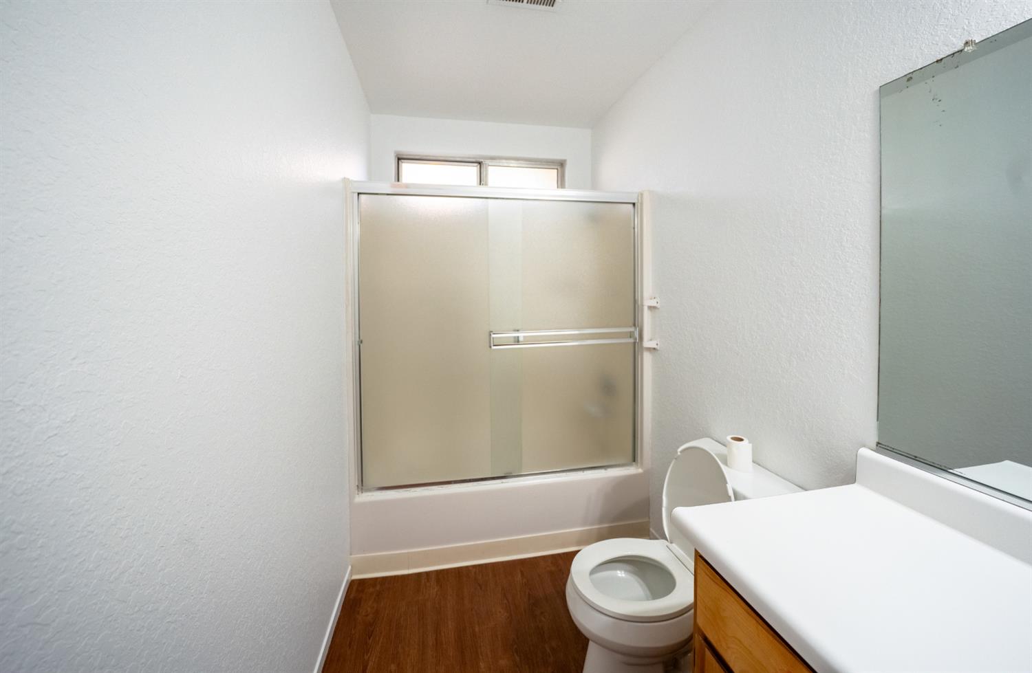 494 Surrey Court Murphys, CA 95247 - Photo 43 of 76 a white toilet sitting next to a bathroom sink