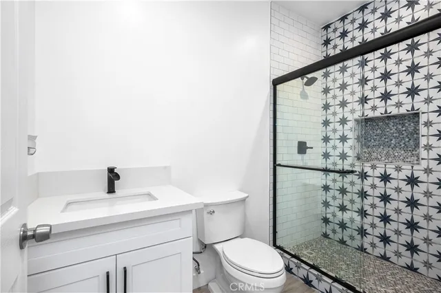 a bathroom with a sink toilet and shower