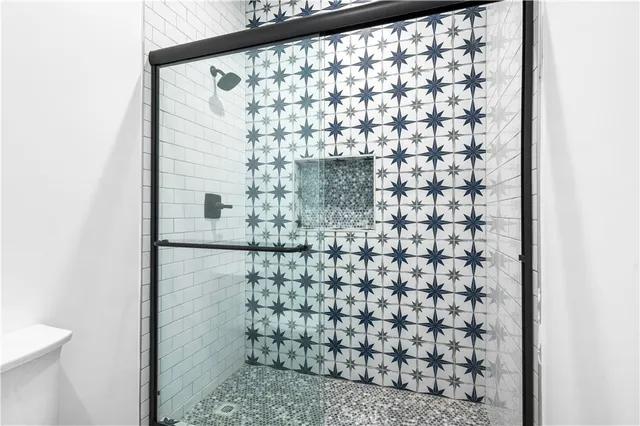a bathroom with a shower and a sink