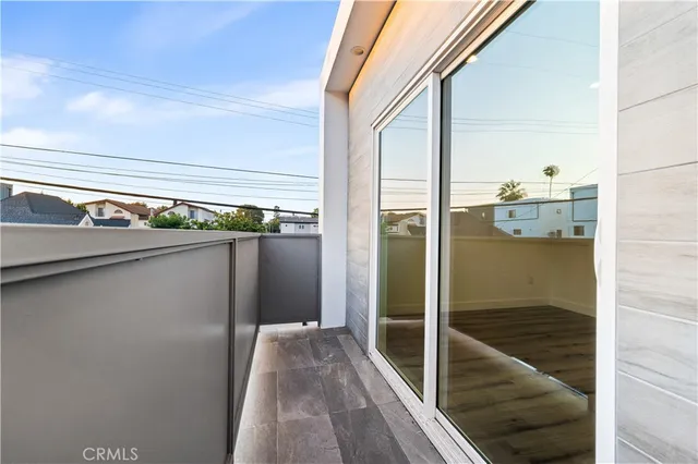 a view of a balcony from an empty room
