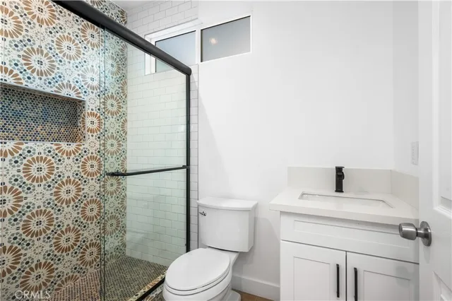 a bathroom with a toilet sink and shower