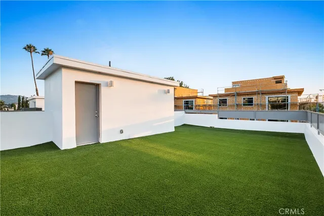 a backyard with a table and chairs a barbeque