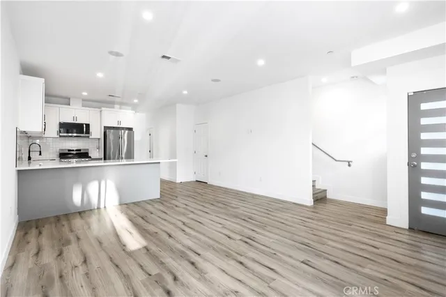 a view of kitchen view with wooden floor and window