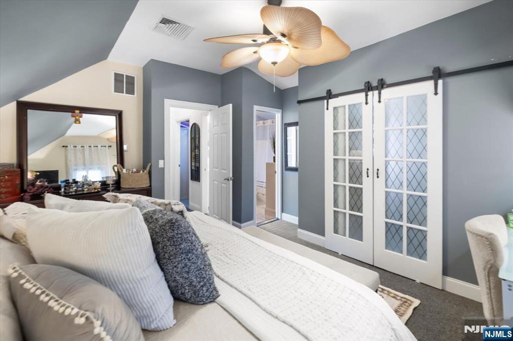 338 South Van Dien Avenue Ridgewood, NJ 07450 - Photo 14 of 33 a spacious bedroom with a large bed and a chandelier