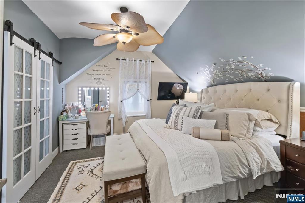 338 South Van Dien Avenue Ridgewood, NJ 07450 - Photo 15 of 33 a bed room with bed and a chandelier