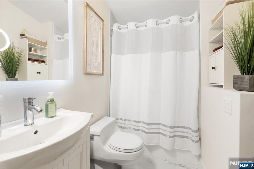 338 South Van Dien Avenue Ridgewood, NJ 07450 - Photo 21 of 33 a bathroom with a sink toilet and shower