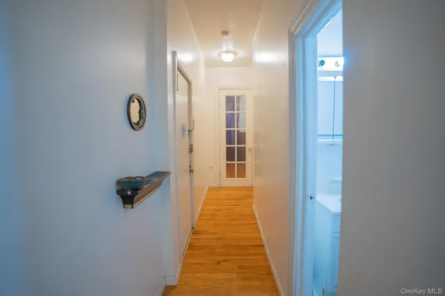 a view of a hallway with wooden floor