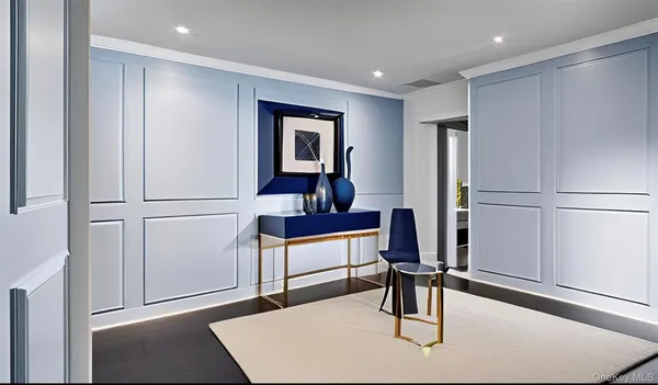 a living room with a refrigerator and a dresser