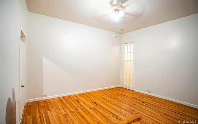 a view of a room with wooden floor and fan