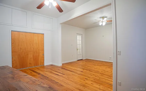 a bedroom with a bed and a chandelier fan