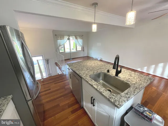 a kitchen with sink stove and refrigerator