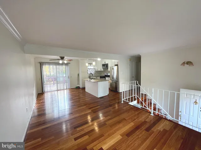 a room with lots of wooden furniture and windows
