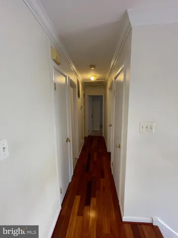 a view of hallway with wooden floor