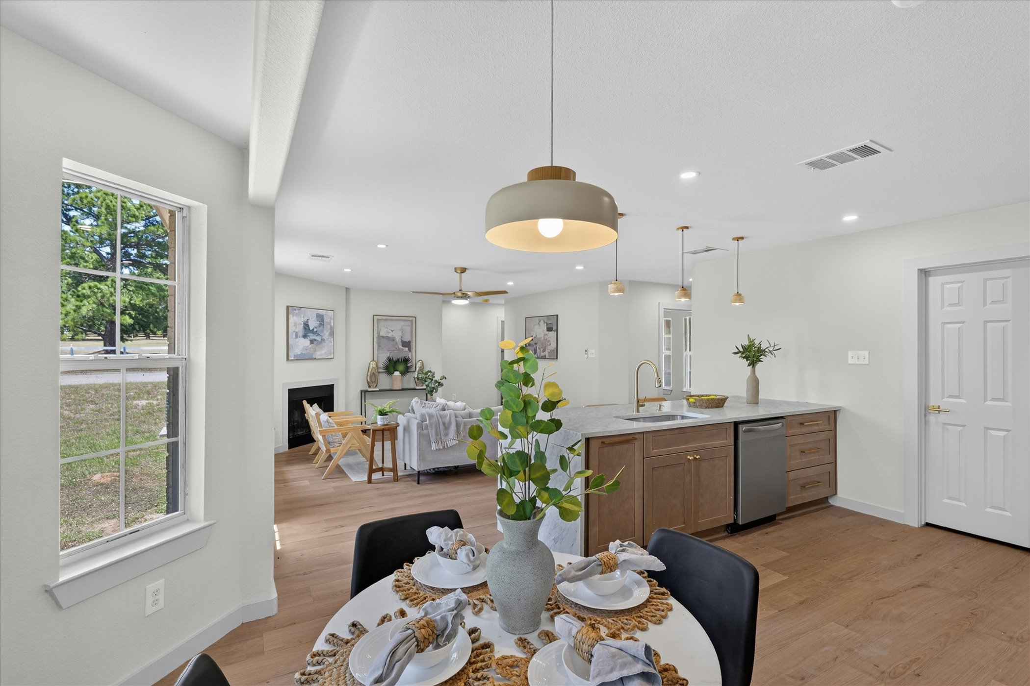258 Pine View Loop Bastrop, TX 78602 - Photo 20 of 40 An open concept design seamlessly connects the dining area, kitchen, and living room.
