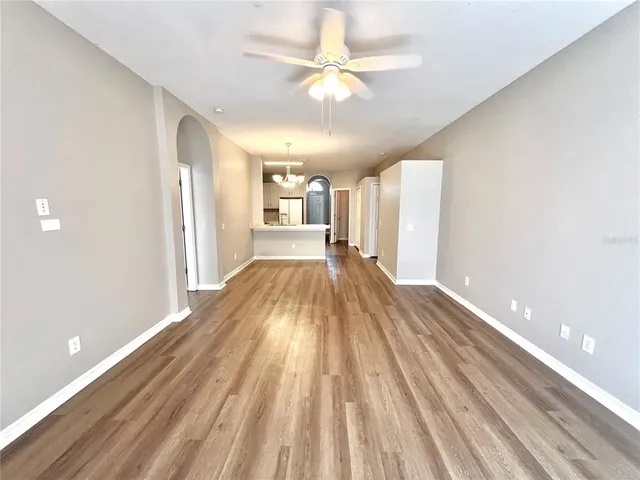 a view of a room with wooden floor and fan