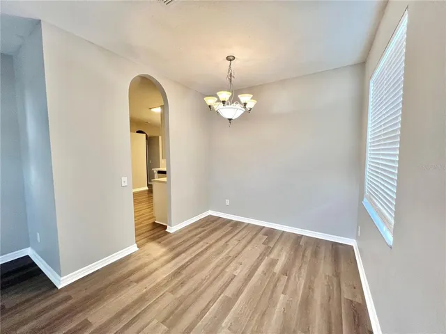 wooden floor in an empty room with a mirror