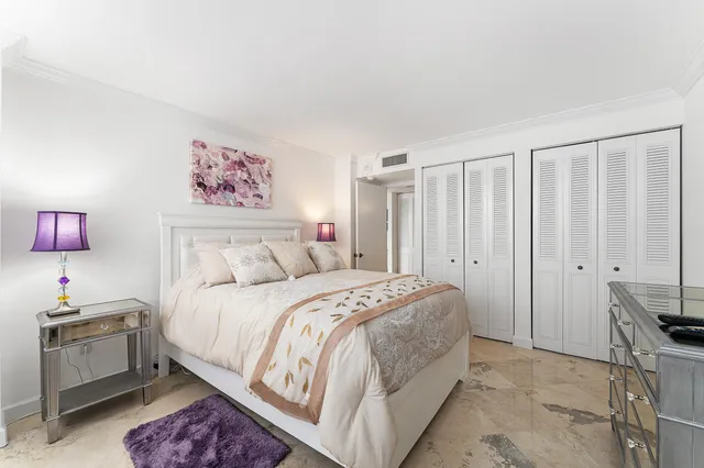 a spacious bedroom with a bed and a window