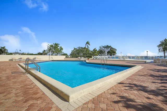 a view of a swimming pool and an outdoor seating