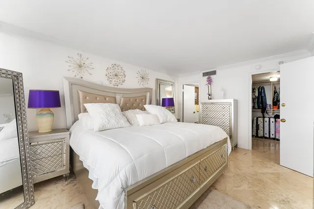 a bed room with a bed and a chair