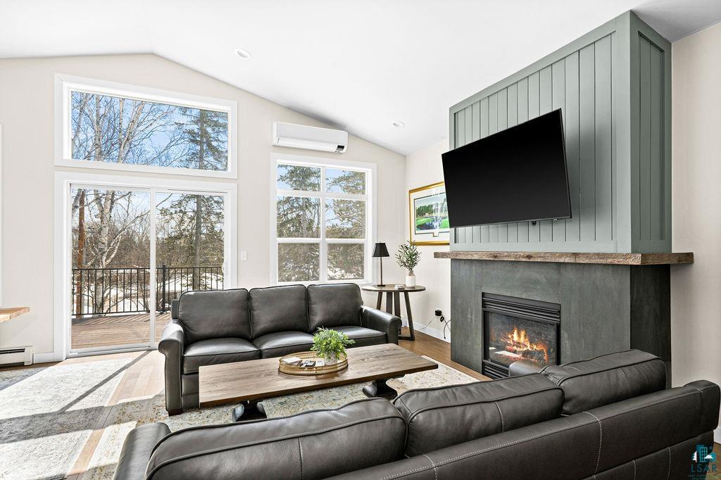 2236 Hoover Street Duluth, MN 55811 - Photo 5 of 52 Living area with wood finished floors, a fireplace, and lofted ceiling