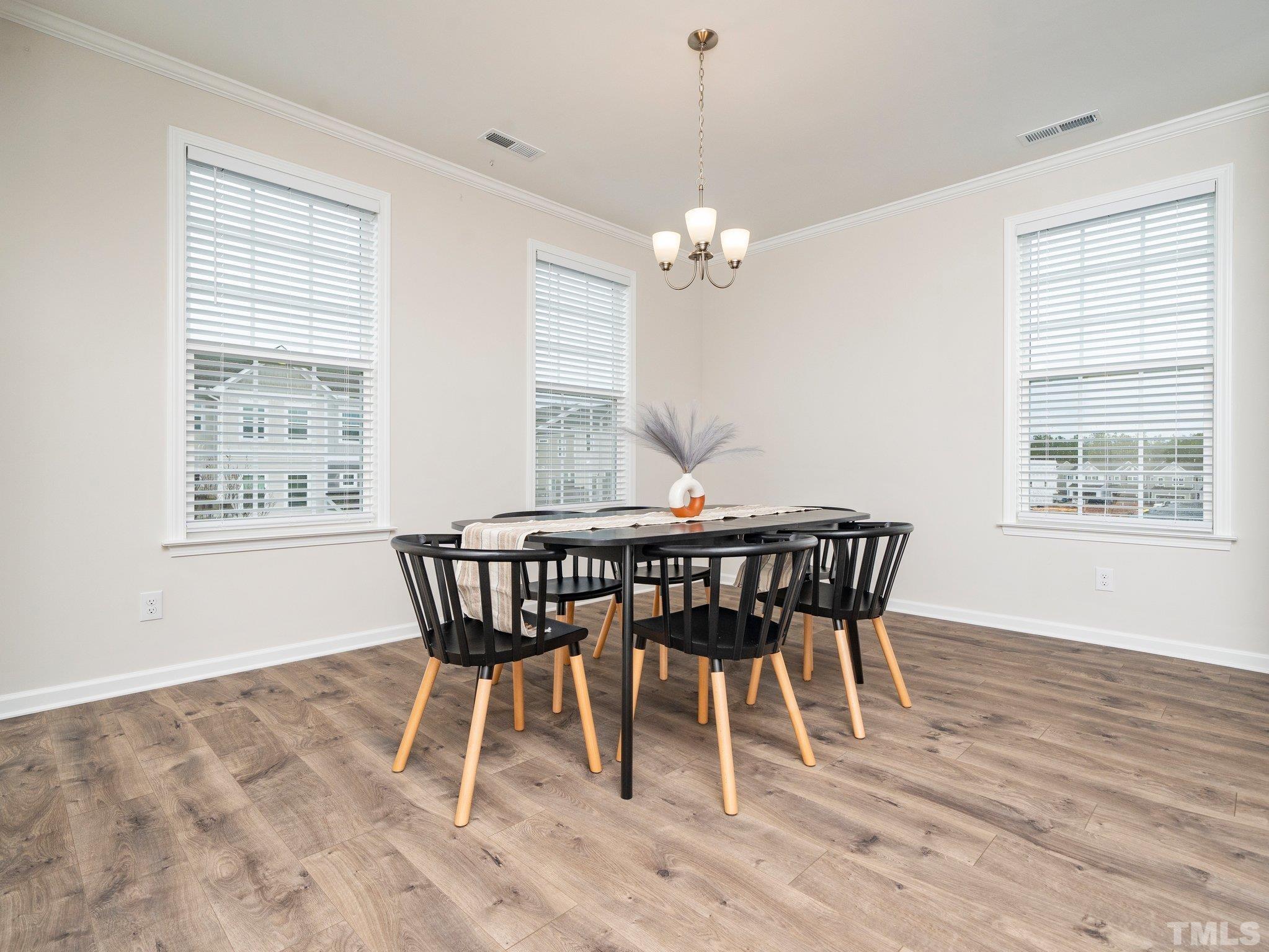 5915 Kayton Street Raleigh, NC 27616 - Photo 11 of 26 a view of a dining room with furniture window and wooden floor