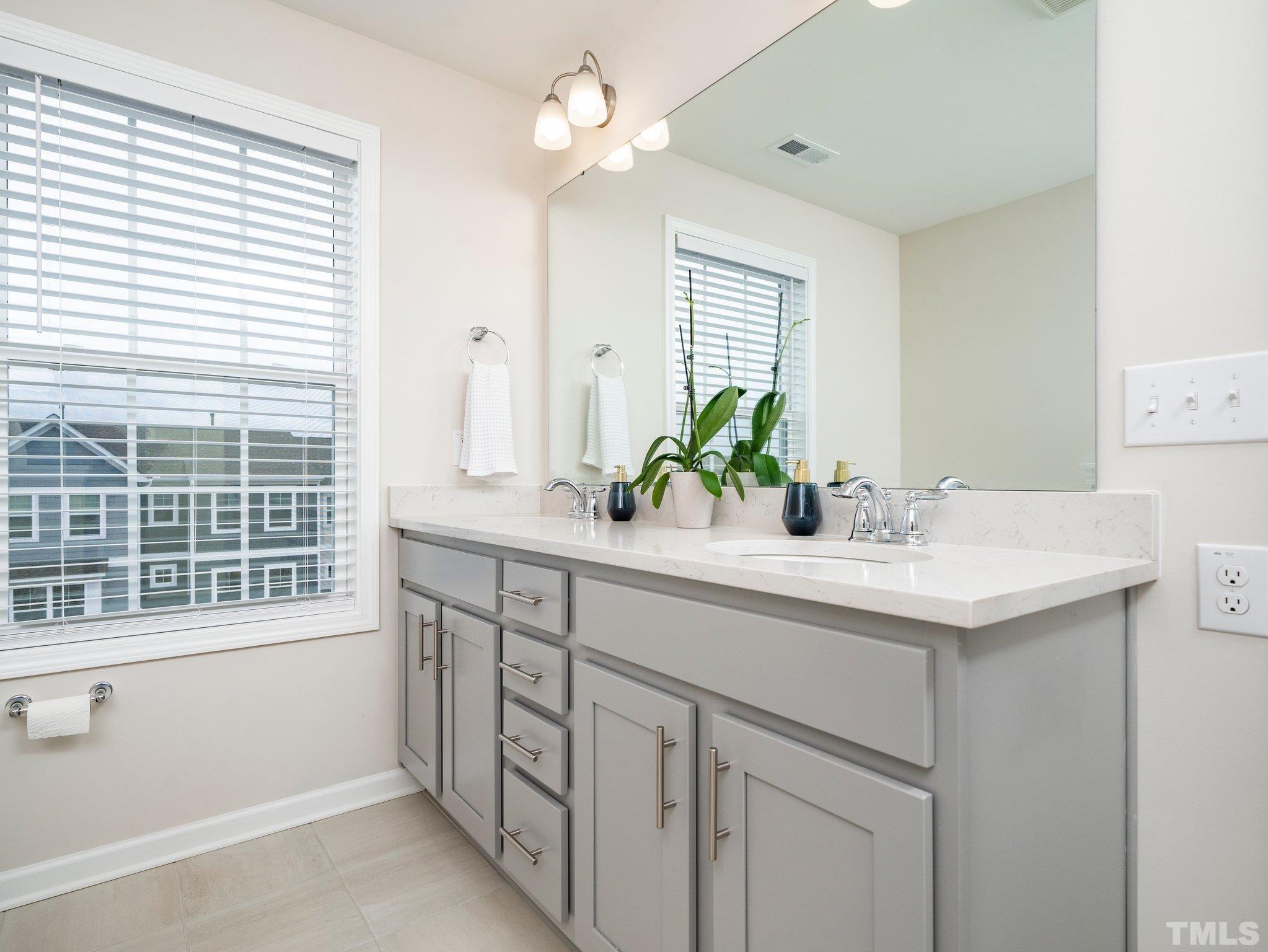 5915 Kayton Street Raleigh, NC 27616 - Photo 16 of 26 a bathroom with a sink double vanity and a mirror