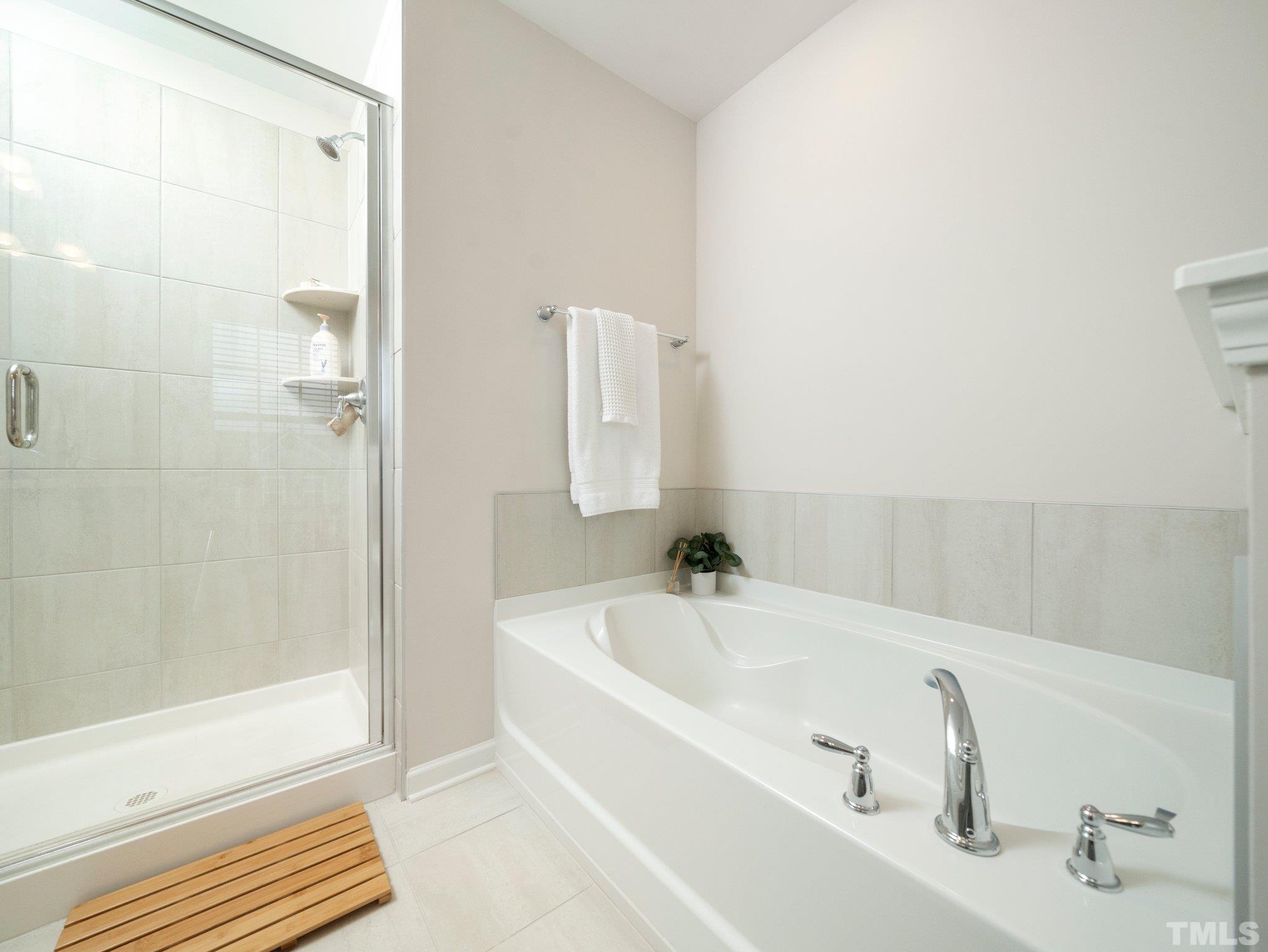 5915 Kayton Street Raleigh, NC 27616 - Photo 17 of 26 a white bath tub sitting next to a white sink