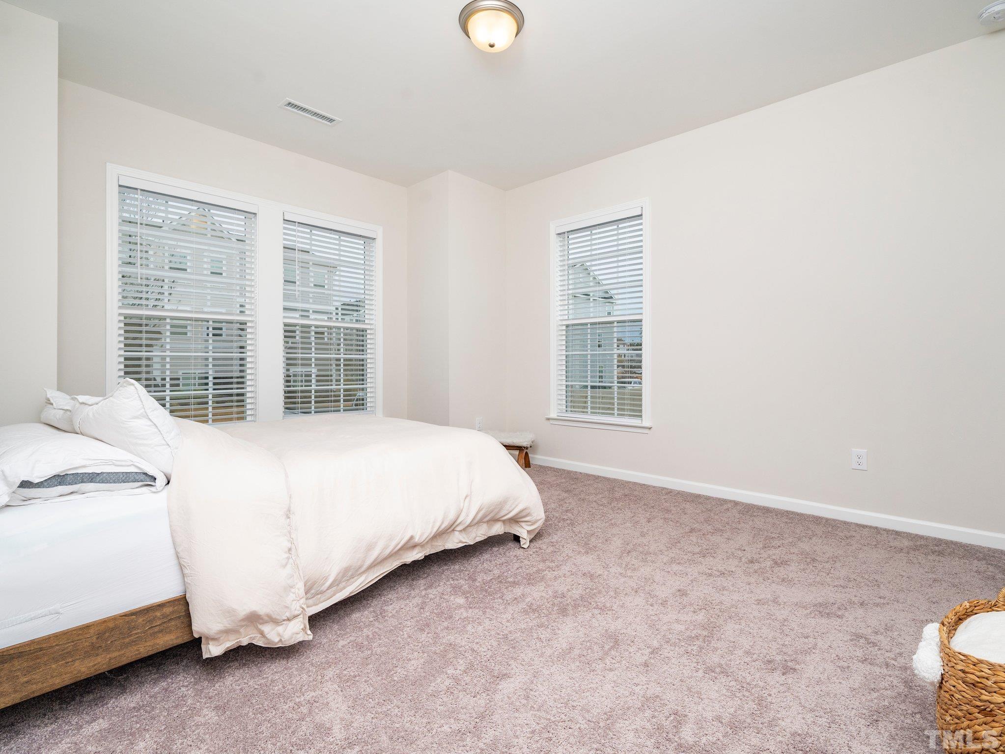 5915 Kayton Street Raleigh, NC 27616 - Photo 18 of 26 a bed sitting in a bedroom next to a window