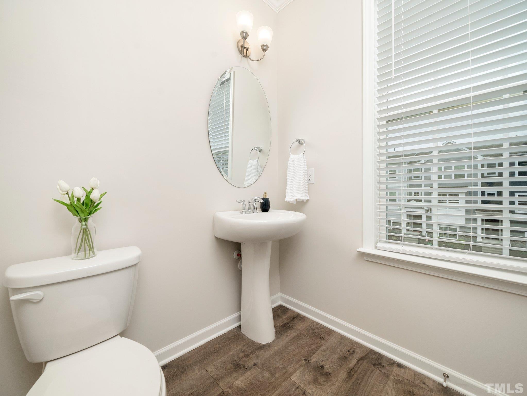 5915 Kayton Street Raleigh, NC 27616 - Photo 22 of 26 a bathroom with a sink a toilet and a mirror