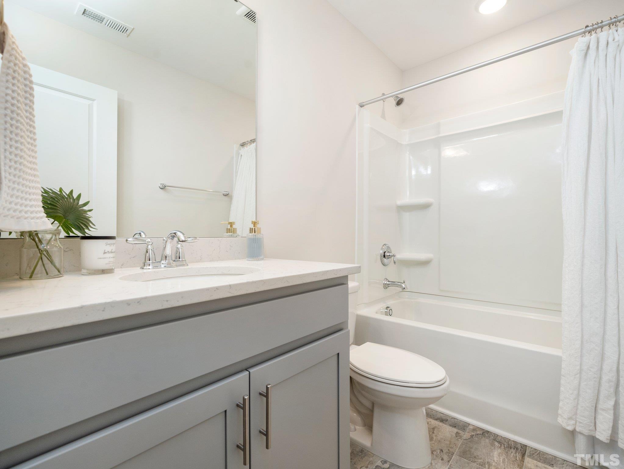 5915 Kayton Street Raleigh, NC 27616 - Photo 23 of 26 a bathroom with a sink a toilet and a bathtub