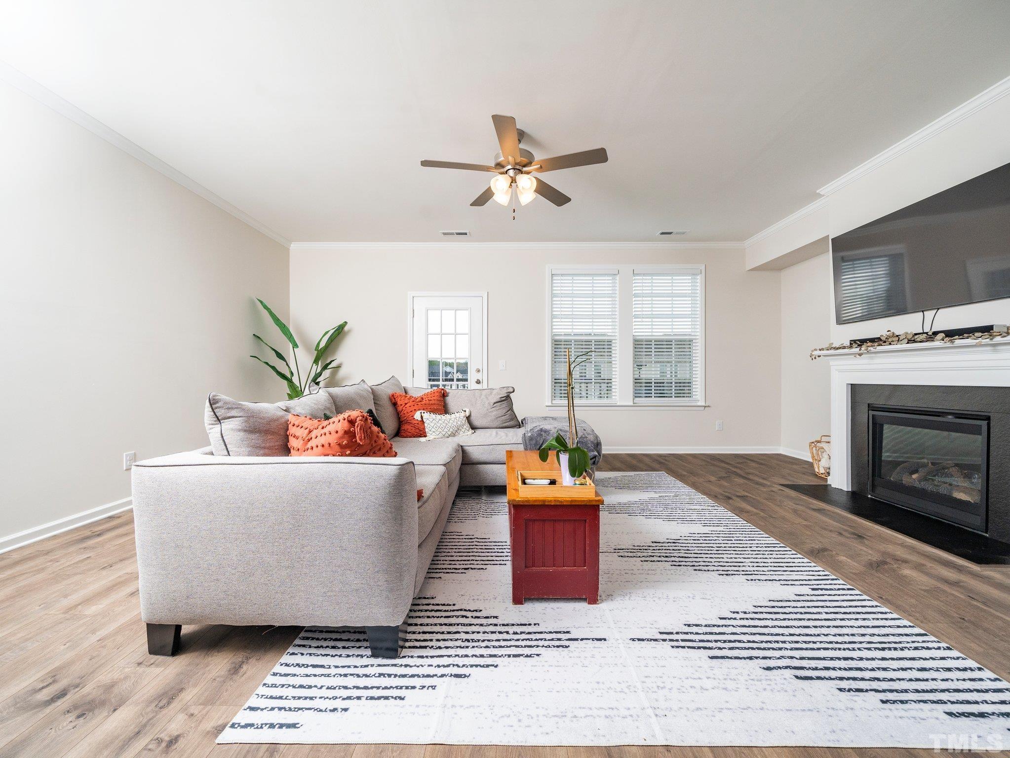 5915 Kayton Street Raleigh, NC 27616 - Photo 10 of 26 a living room with furniture and a fireplace