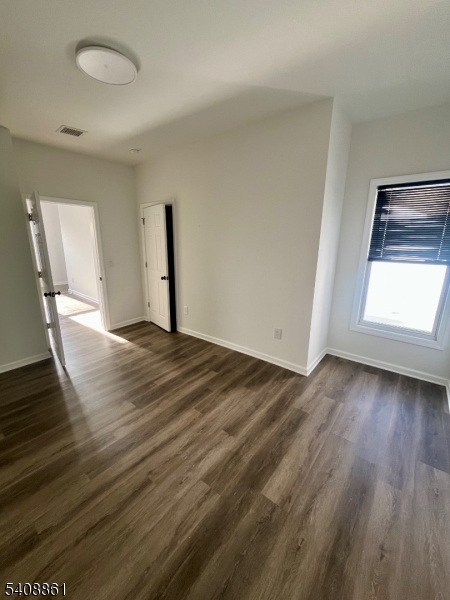 53 High Street, Unit A Newton, NJ 07860 - Photo 12 of 13 an empty room with wooden floor and windows