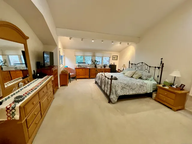 a bedroom with furniture and a large window