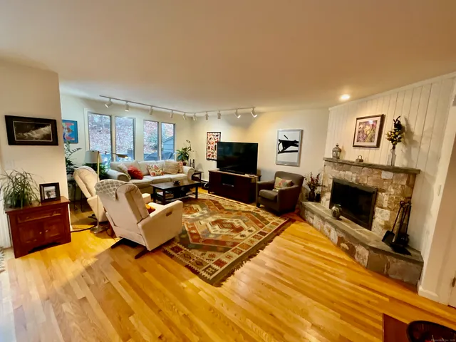 a living room with furniture a flat screen tv and a fireplace