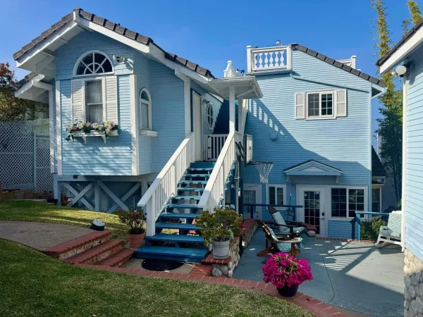 a front view of a house with a garden