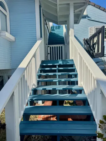a view of a balcony with wooden fence
