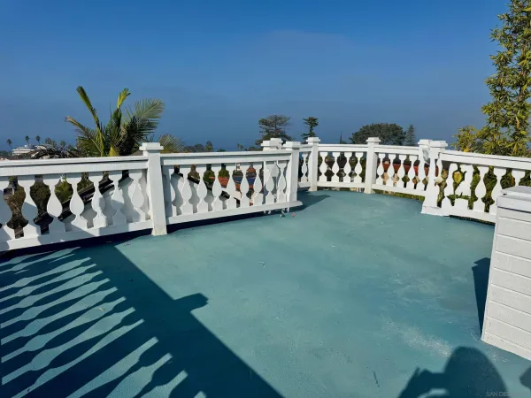 a view of a balcony with wooden floor